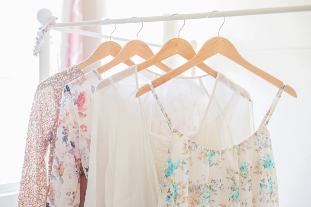 Selection of beautiful floral dresses hanging up