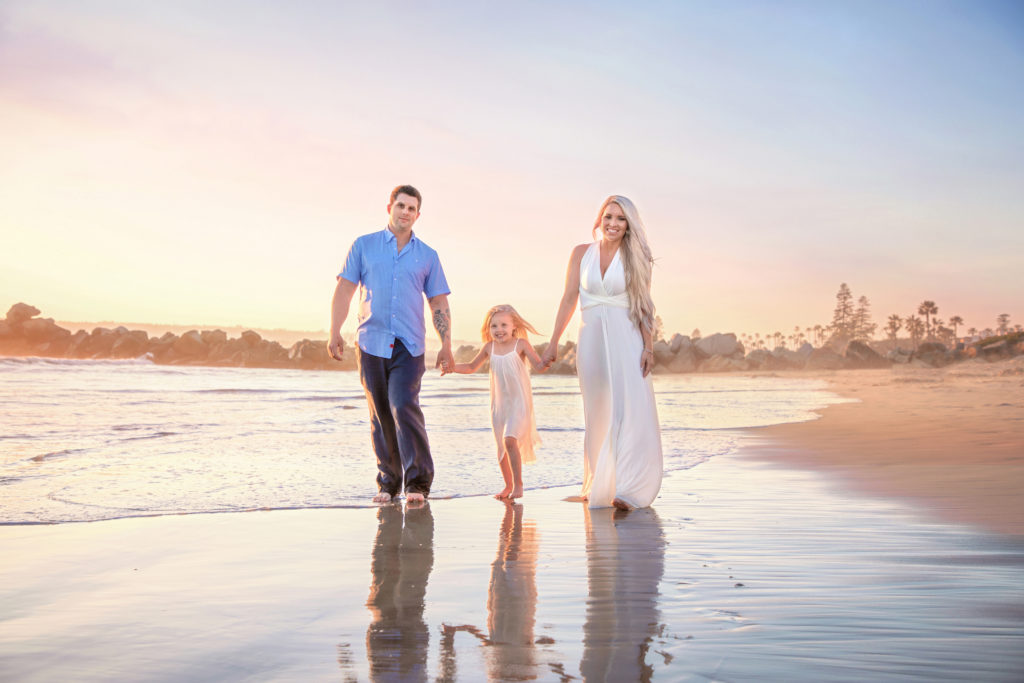 Family walking along the beach at the Hotel Del Coronado