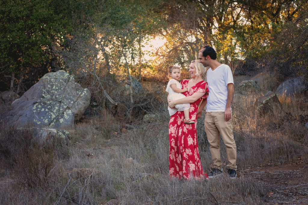 Husband and wife and their little girl at sunset in Felicita Park