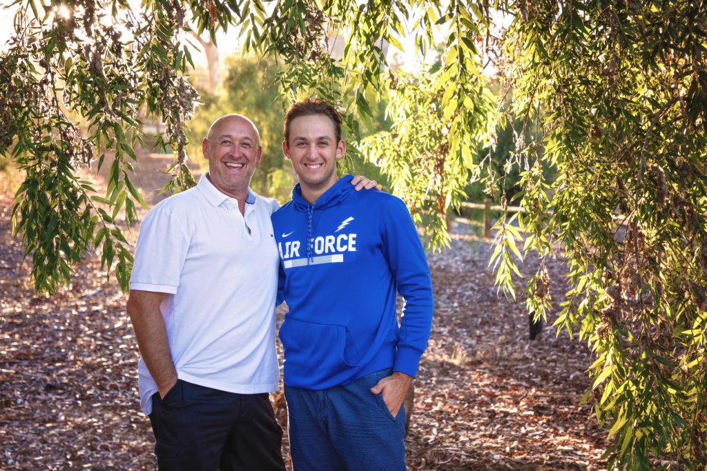 Father and son standing under a tree at Olivenhain Town Hall in Encinitas.