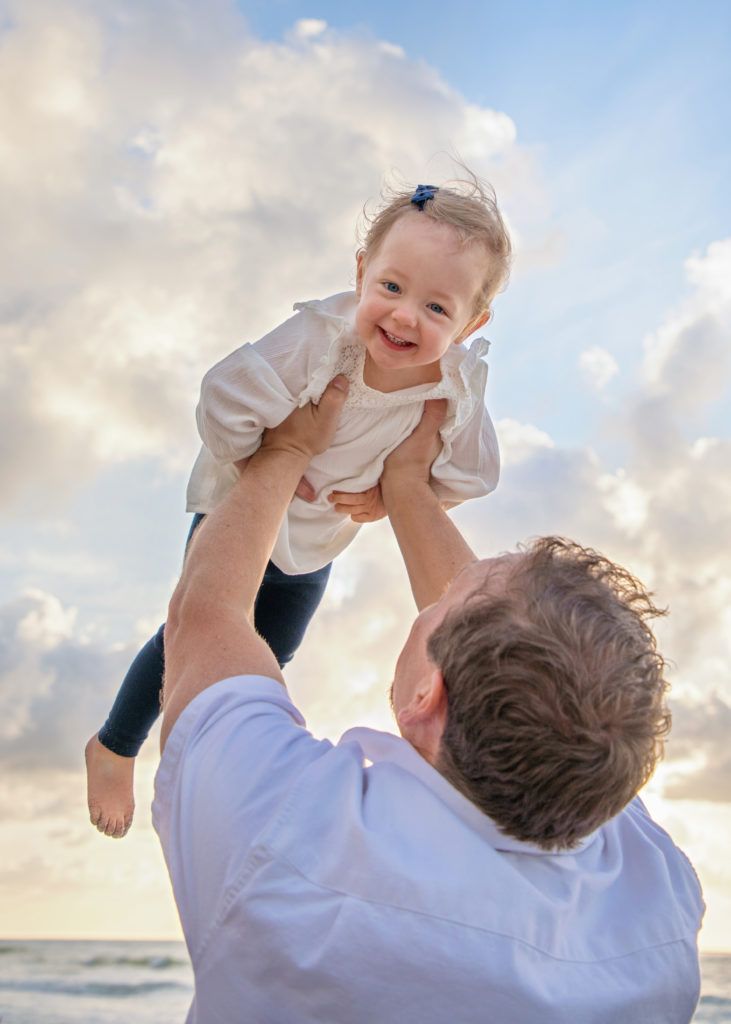 Father lifting his little girl up in the air