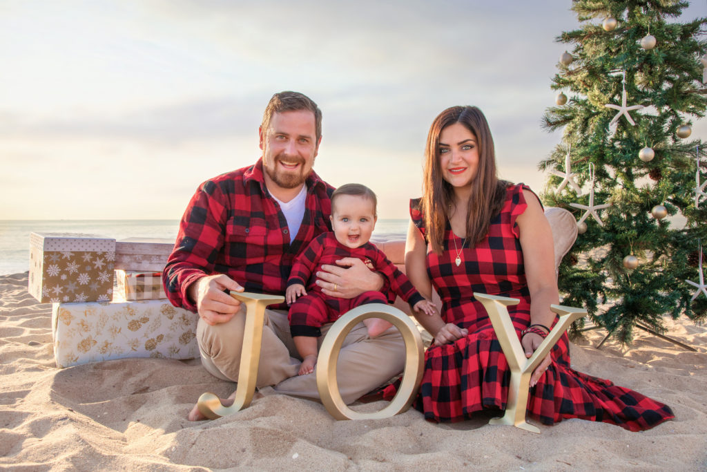 San Diego Family sitting on the beach with a Christmas tree