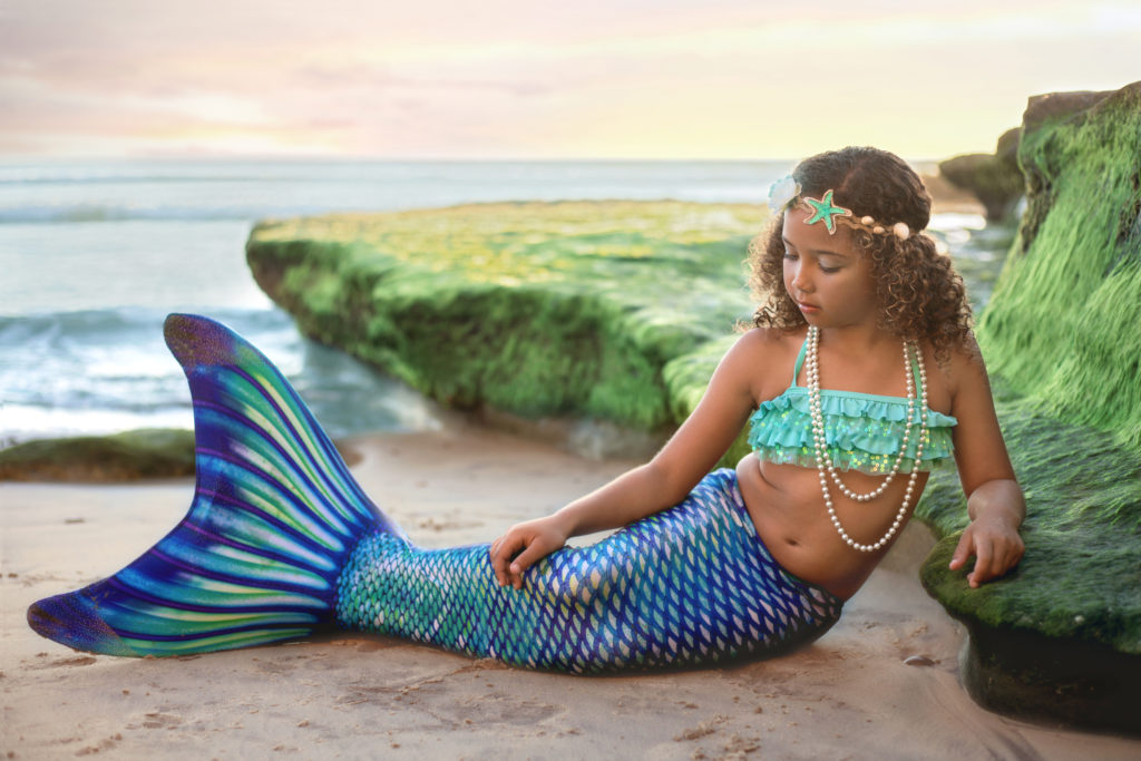 San Diego Mermaid looking at her tail
