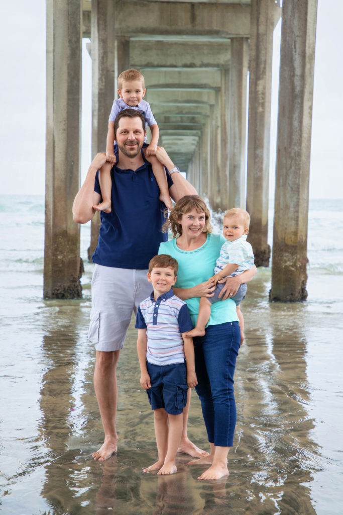 Family standing underneath Scripps Pier in La Jolla