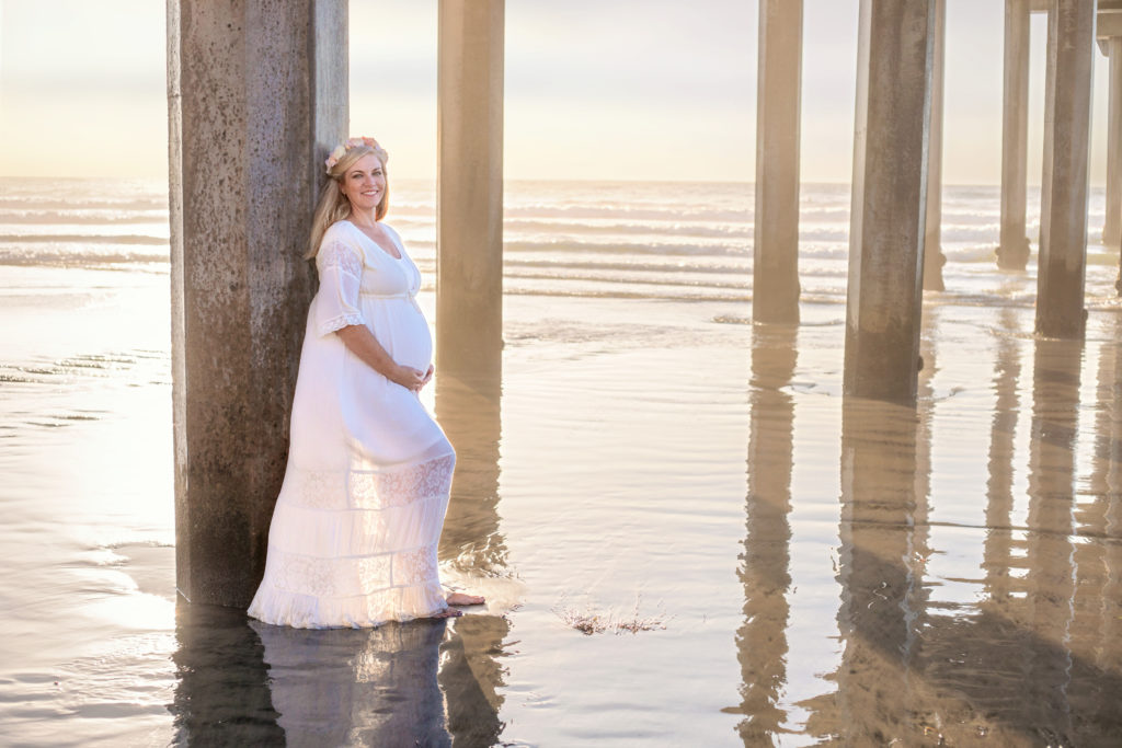 Woman in boho dress at Scripps Pier maternity shoot