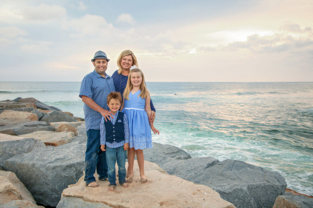 Family standing on South Ponto Beach jetty in Carlsbad