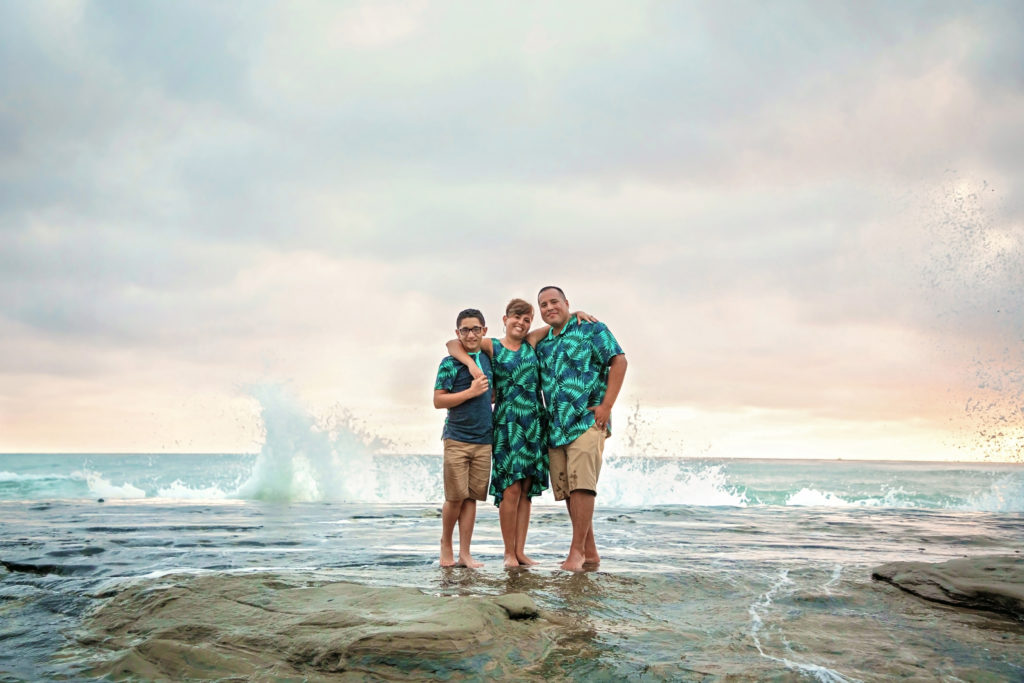 Family standing on the rocks at Windandsea