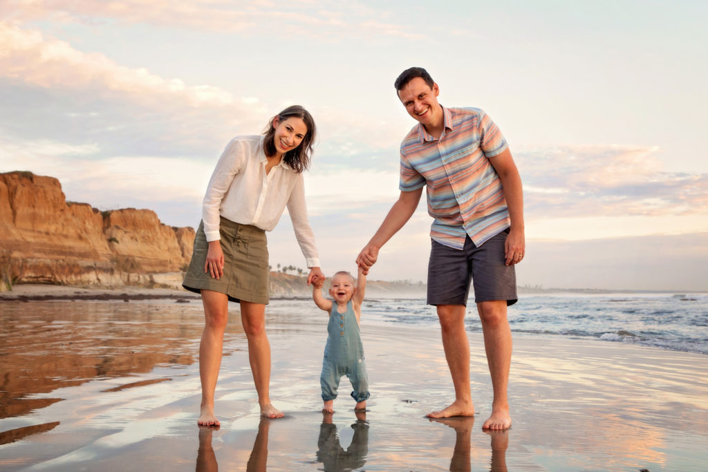 Family holding hands on a San Diego Beach.