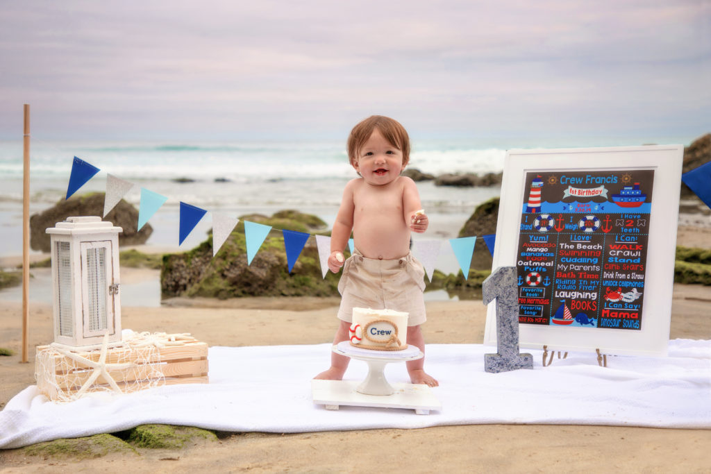 Little boy nautical cake smash on the beach at Scripps Pier.