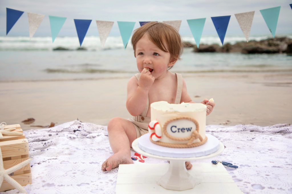 Baby boy nautical cake smash on the beach at Scripps Pier in La Jolla