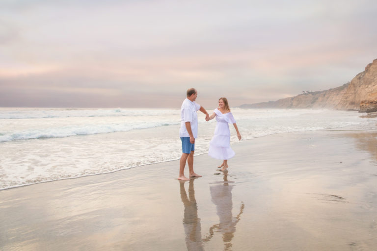 Husband and wife dancing on the beach